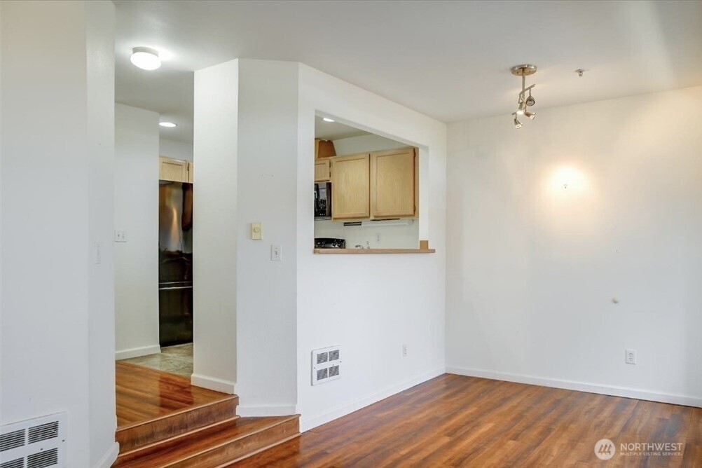 8515 244th Street Southwest, Unit A2 Edmonds, WA 98026 - Photo 15 of 22 a view of a hallway with wooden floor and closet