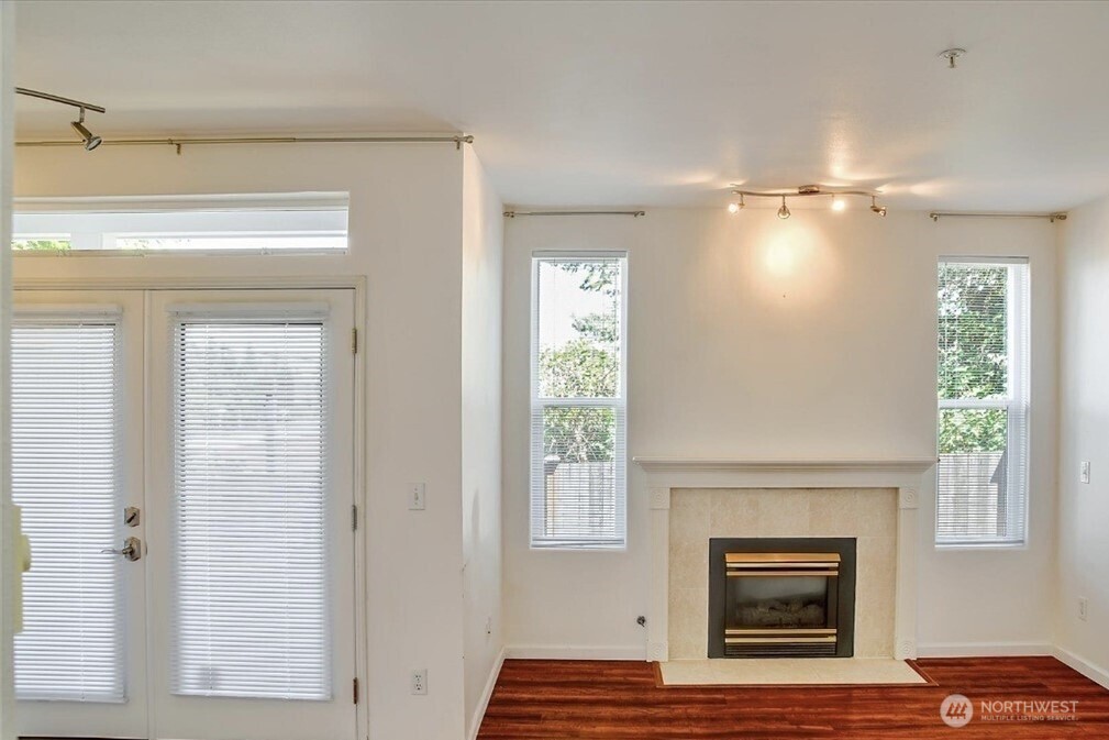 8515 244th Street Southwest, Unit A2 Edmonds, WA 98026 - Photo 18 of 22 a view of empty room with a fireplace and wooden floor