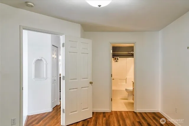 a view of bedroom with wooden floor