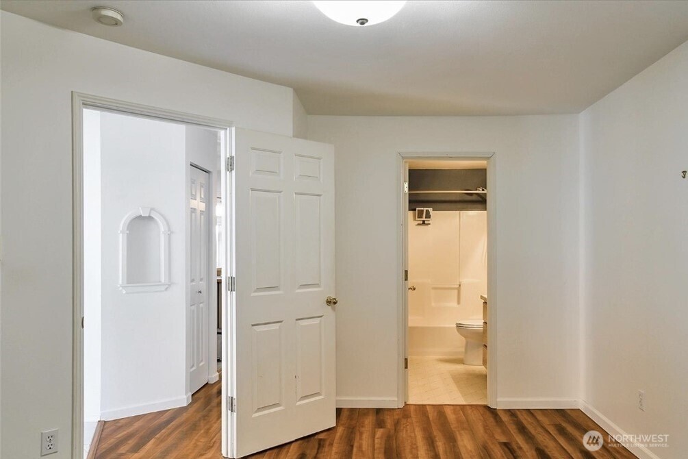 8515 244th Street Southwest, Unit A2 Edmonds, WA 98026 - Photo 5 of 22 a view of a bedroom with wooden floor and closet
