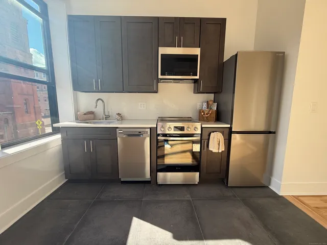 a kitchen with stainless steel appliances a refrigerator stove and microwave