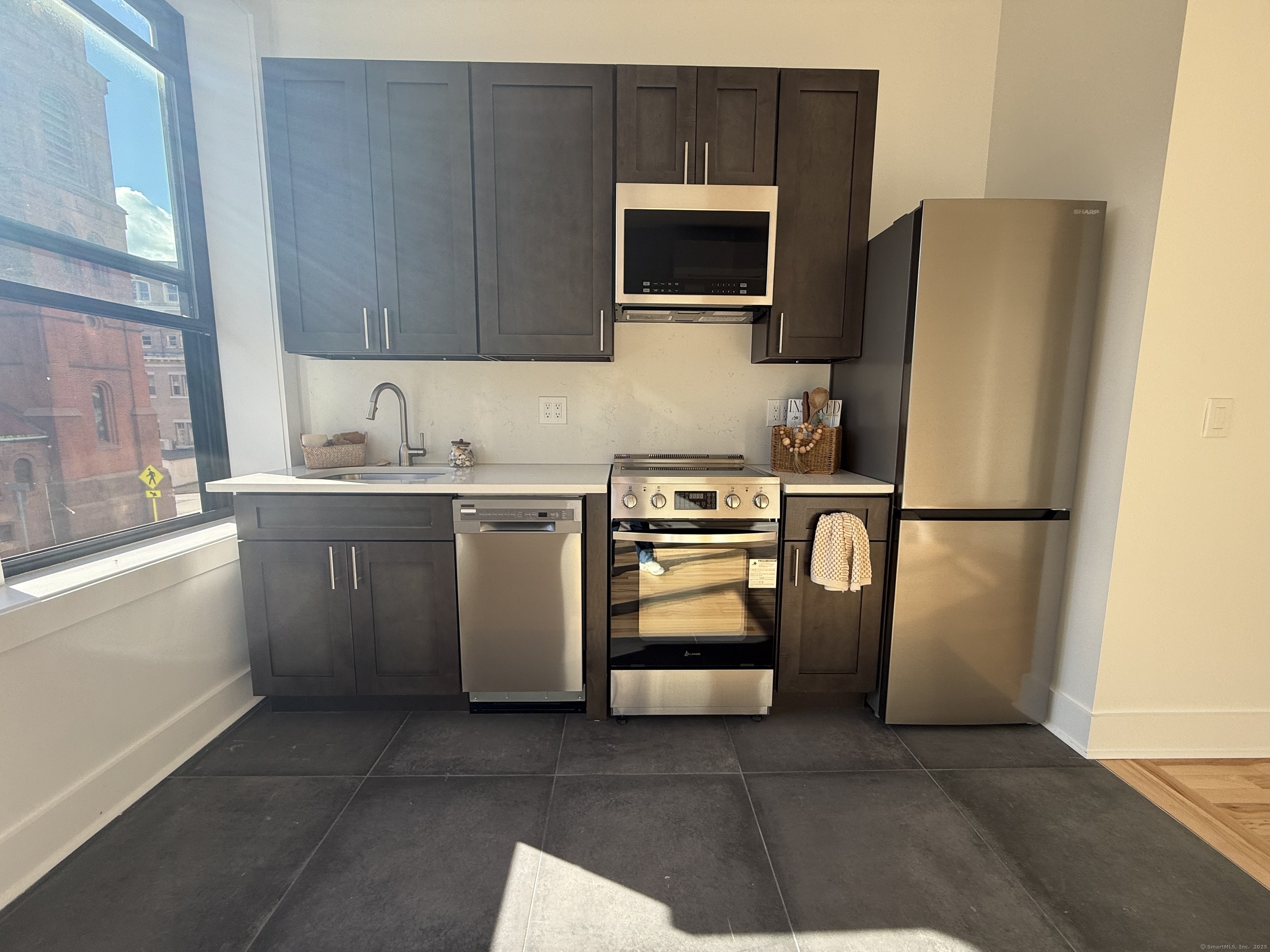 253 State Street, Unit 3R New London, CT 06320 - Photo 2 of 7 a kitchen with stainless steel appliances a refrigerator stove and microwave