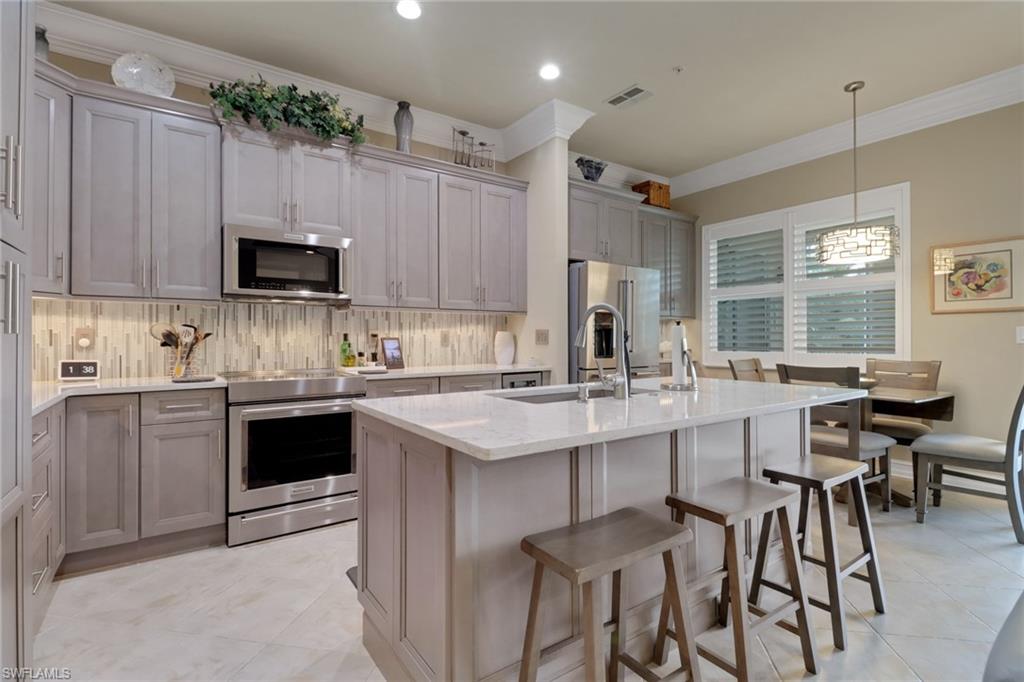 3620 Lansing Loop, Unit 202 Estero, FL 33928 - Photo 11 of 40 a kitchen with a sink and cabinets