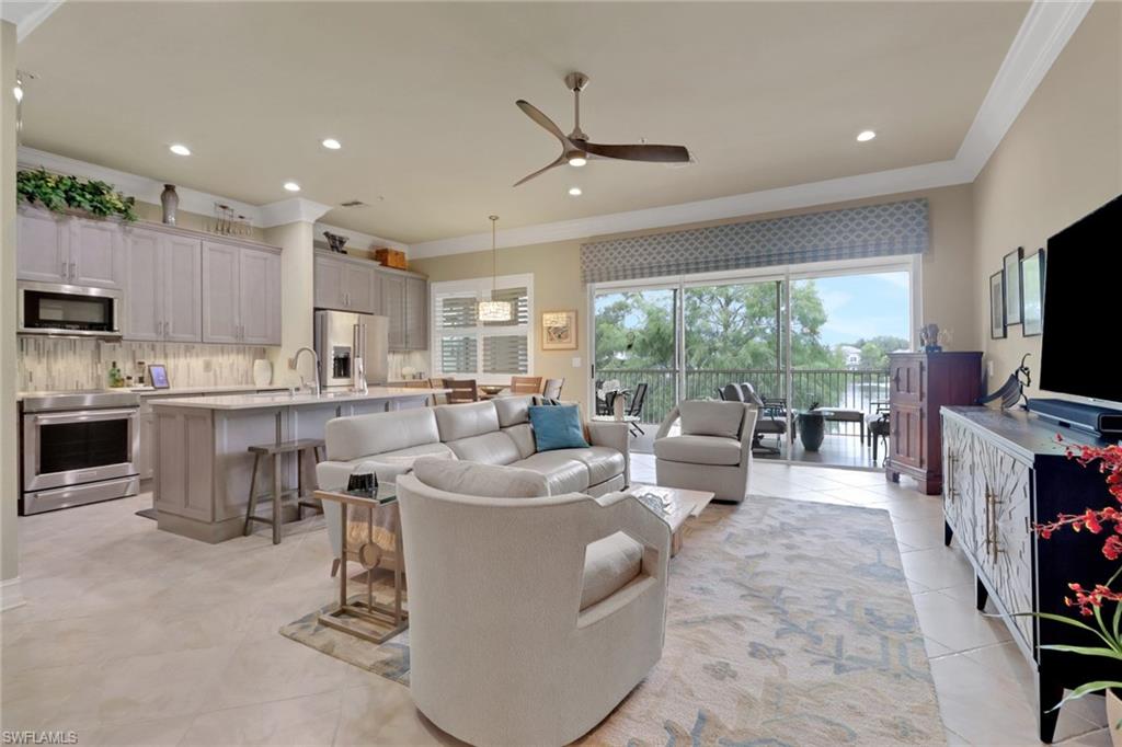 3620 Lansing Loop, Unit 202 Estero, FL 33928 - Photo 12 of 40 a living room with furniture a flat screen tv and a large window