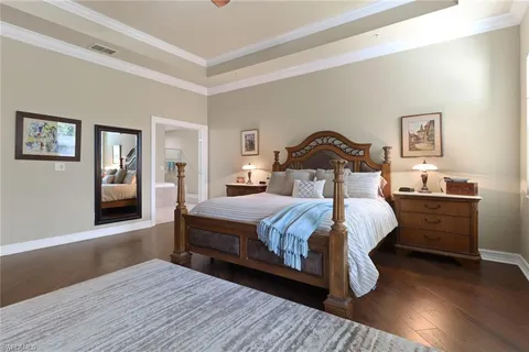 a bedroom with a bed and a night stand