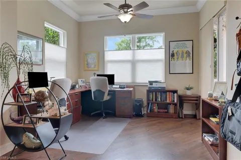 a view of a workspace with furniture and a window