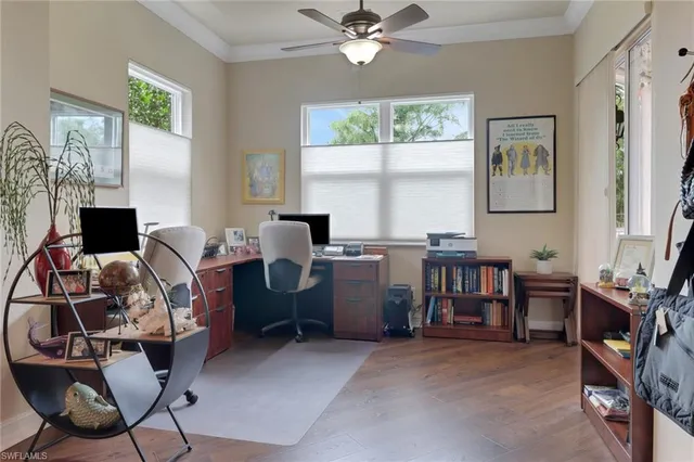 a view of a workspace with furniture and a window