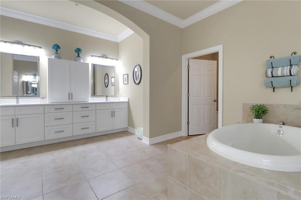 3620 Lansing Loop, Unit 202 Estero, FL 33928 - Photo 17 of 40 a spacious bathroom with a tub sink and mirror