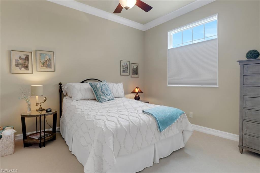 3620 Lansing Loop, Unit 202 Estero, FL 33928 - Photo 20 of 40 a bedroom with a bed and a chandelier