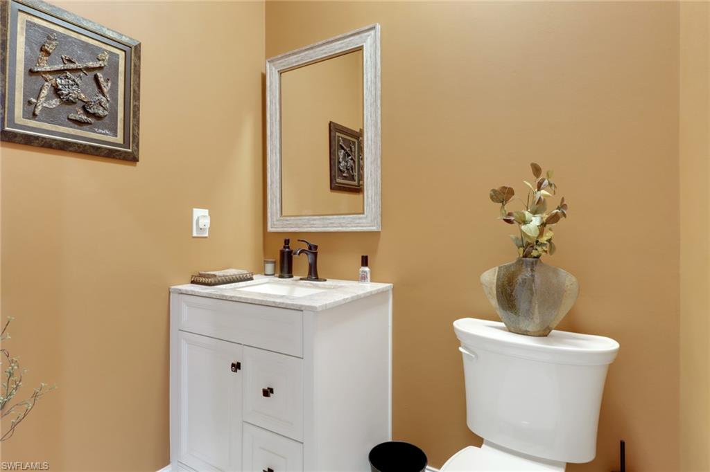 3620 Lansing Loop, Unit 202 Estero, FL 33928 - Photo 23 of 40 a bathroom with a toilet a sink and mirror