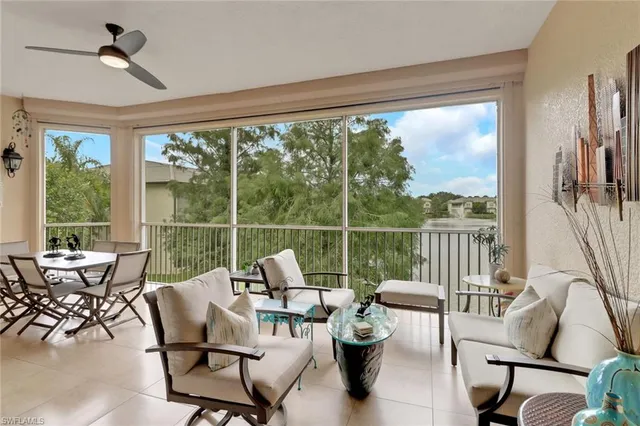 a balcony with furniture and a large window