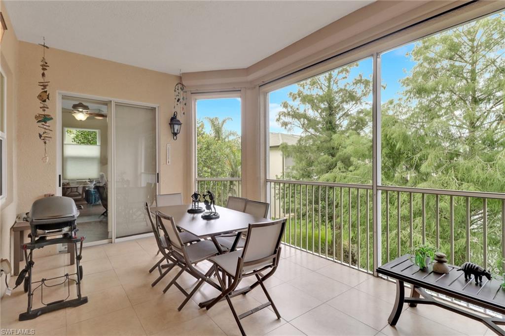3620 Lansing Loop, Unit 202 Estero, FL 33928 - Photo 26 of 40 a dining room with furniture water view and a floor to ceiling window