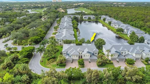 an aerial view of residential houses with outdoor space and river