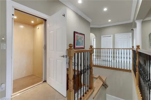 a view of a hallway with windows and stairs