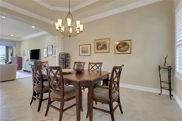 a view of a dining room with furniture and chandelier