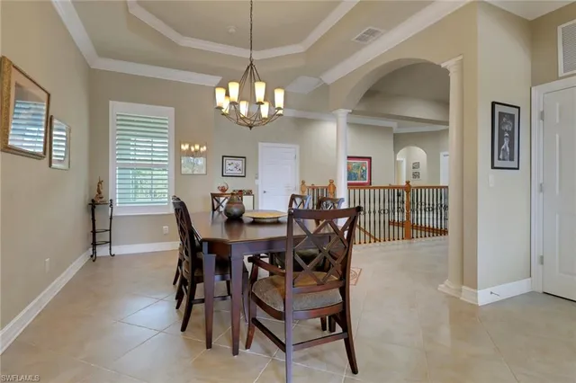 a view of a dining room with furniture and chandelier