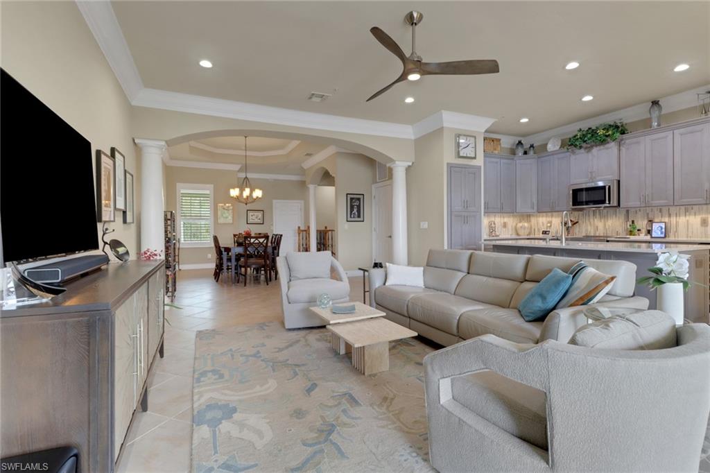 3620 Lansing Loop, Unit 202 Estero, FL 33928 - Photo 7 of 40 a living room with furniture kitchen view and a flat screen tv