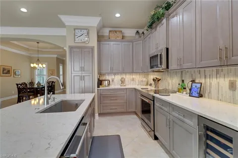 a kitchen with granite countertop a sink stainless steel appliances and cabinets