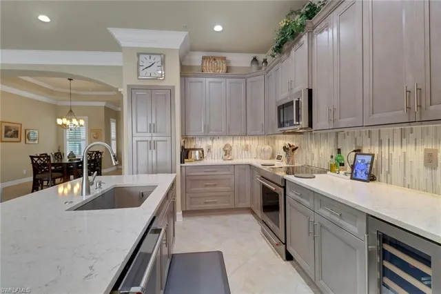 a kitchen with granite countertop a sink stainless steel appliances and cabinets