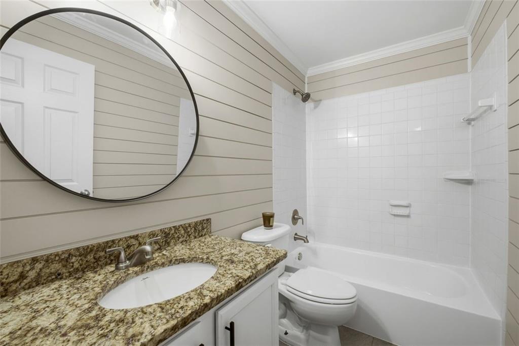 210 Sampson Street Northeast, Unit 5 Atlanta, GA 30312 - Photo 14 of 21 a bathroom with a granite countertop sink toilet and shower