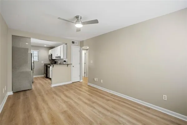 a living room with furniture and kitchen view