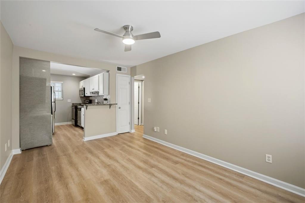 210 Sampson Street Northeast, Unit 5 Atlanta, GA 30312 - Photo 4 of 21 a view of a kitchen with wooden floor electronic appliances and window
