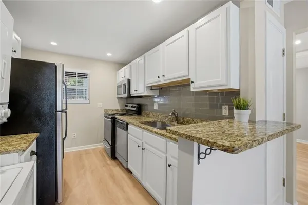 a kitchen with a stove microwave and sink