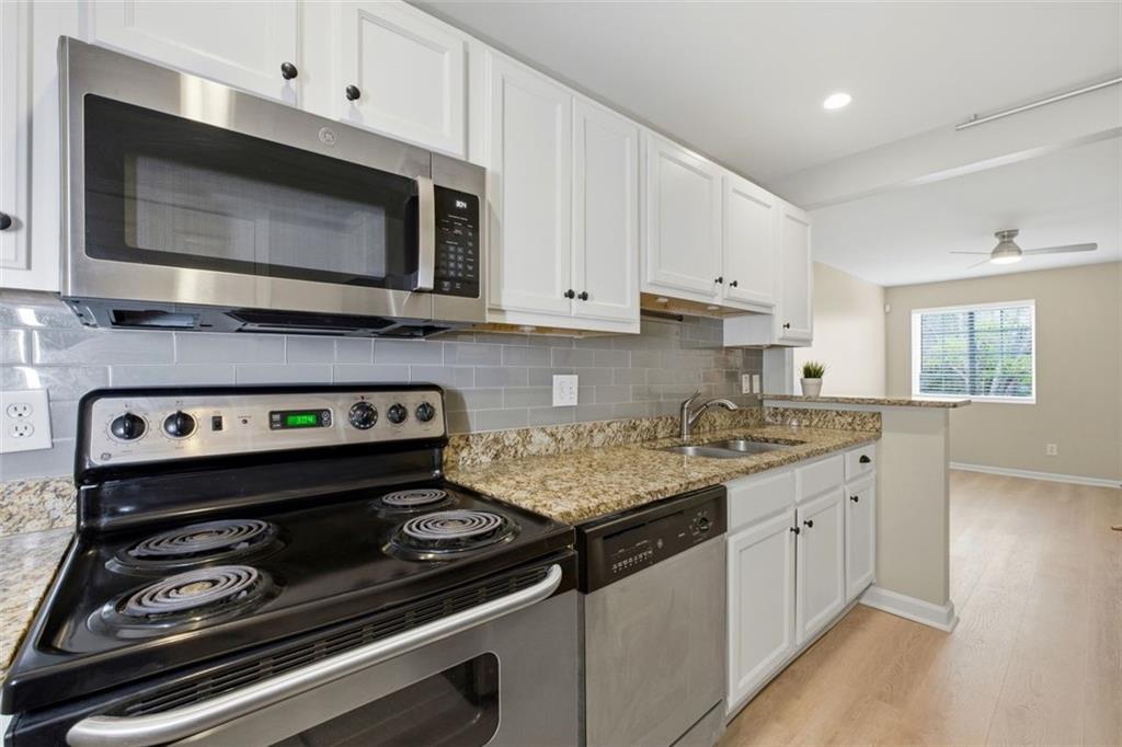 210 Sampson Street Northeast, Unit 5 Atlanta, GA 30312 - Photo 8 of 21 a kitchen with a stove microwave and sink