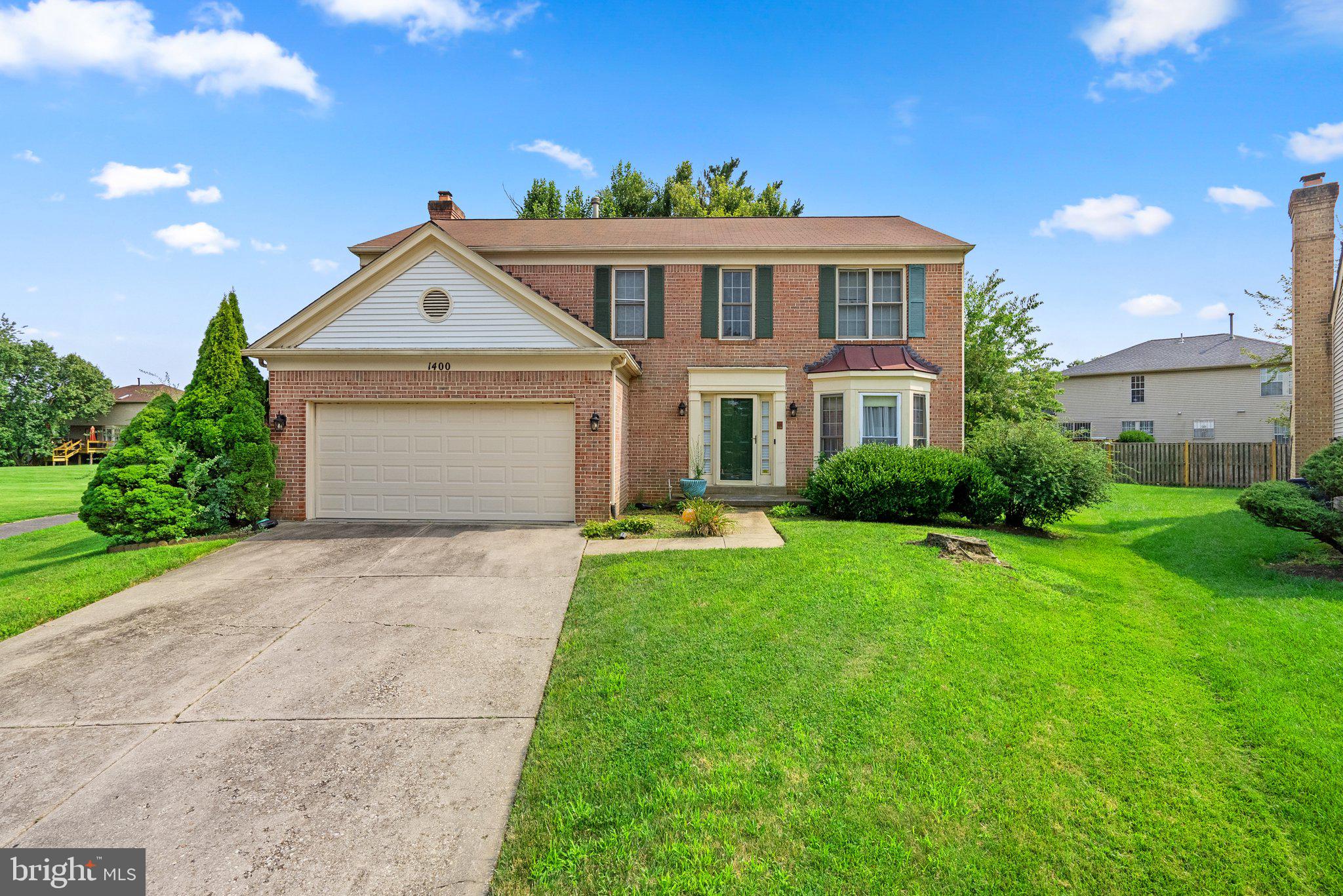 1400 Baytree Terrace Bowie, MD 20721 - Photo 2 of 39 a front view of a house with a yard and garage