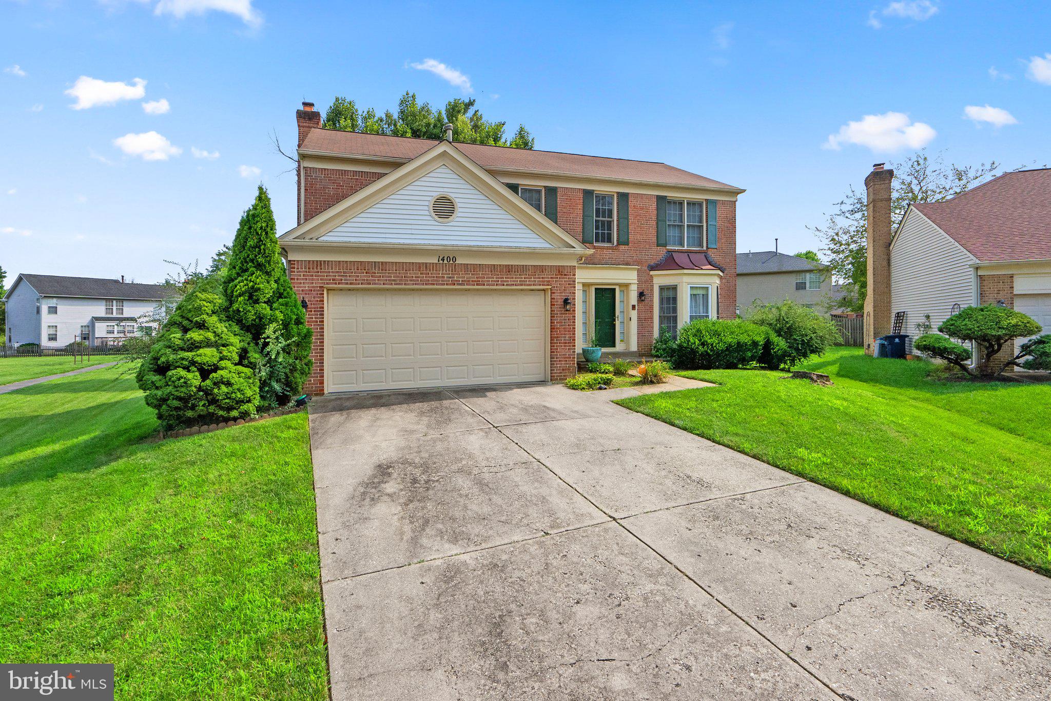 1400 Baytree Terrace Bowie, MD 20721 - Photo 3 of 39 a front view of a house with a yard and garage