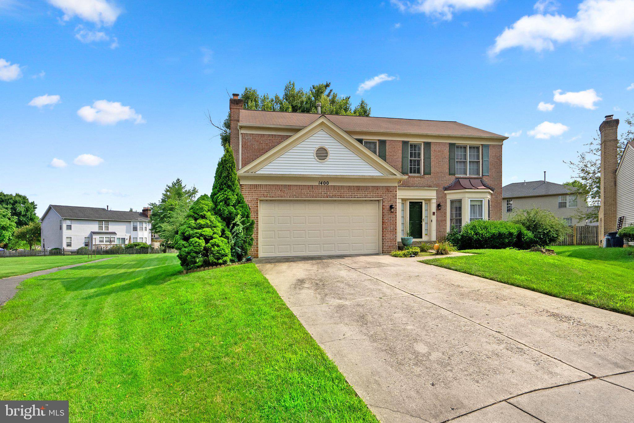1400 Baytree Terrace Bowie, MD 20721 - Photo 4 of 39 a front view of a house with a yard and garage