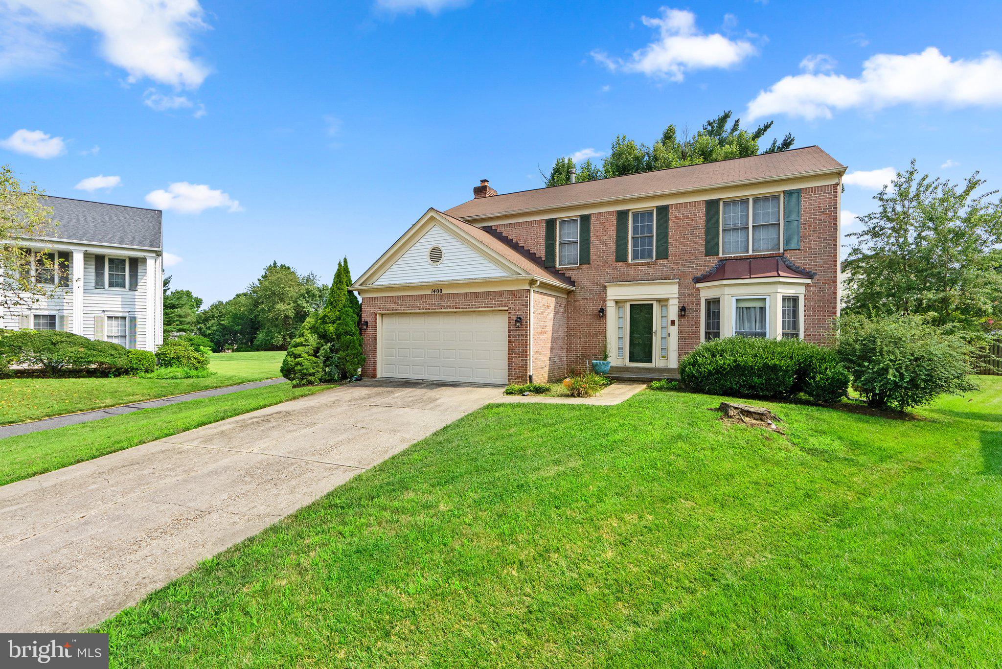 1400 Baytree Terrace Bowie, MD 20721 - Photo 5 of 39 a front view of a house with a yard and garage