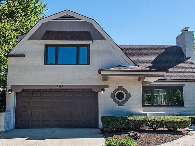 243 Longcommon Road Riverside, IL 60546 - Photo 1 of 25 a front view of a house with a yard