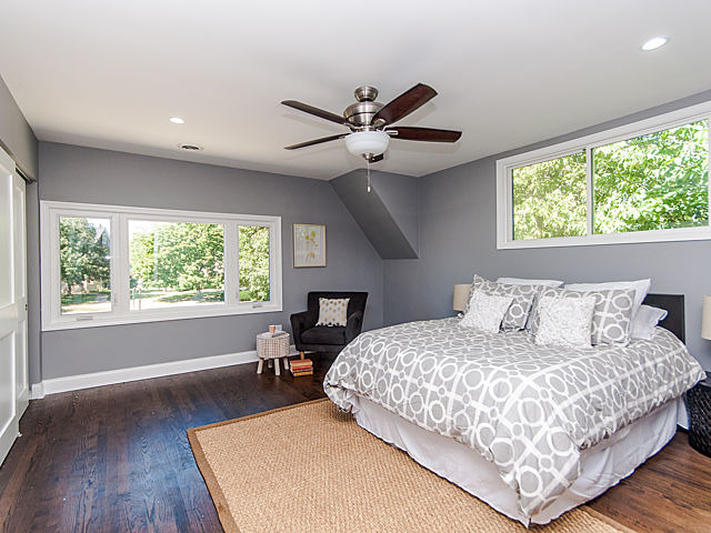 243 Longcommon Road Riverside, IL 60546 - Photo 16 of 25 a bedroom with a large bed chandelier and a window