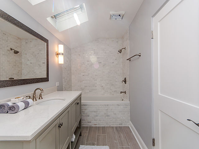 243 Longcommon Road Riverside, IL 60546 - Photo 18 of 25 a bathroom with a sink a toilet a shower and a mirror