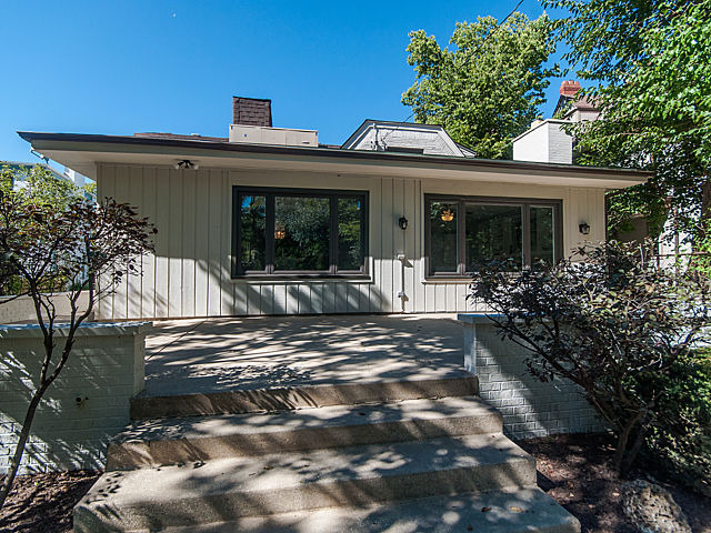 243 Longcommon Road Riverside, IL 60546 - Photo 23 of 25 a view of a house with potted plants and large trees