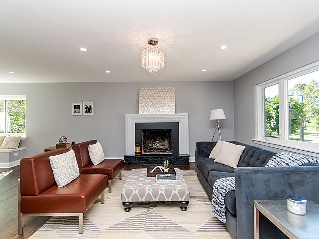 243 Longcommon Road Riverside, IL 60546 - Photo 4 of 25 a living room with furniture a fireplace and a large window