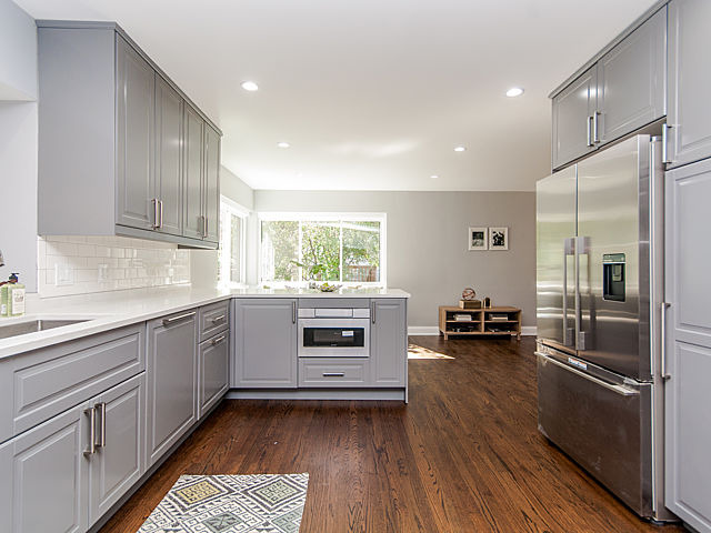 243 Longcommon Road Riverside, IL 60546 - Photo 6 of 25 a kitchen with a refrigerator stove and wooden cabinets