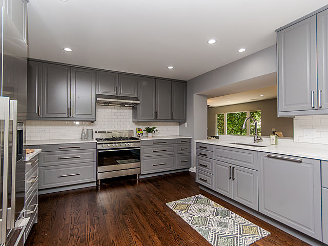 243 Longcommon Road Riverside, IL 60546 - Photo 9 of 25 a kitchen with stainless steel appliances kitchen island granite countertop a stove and a sink