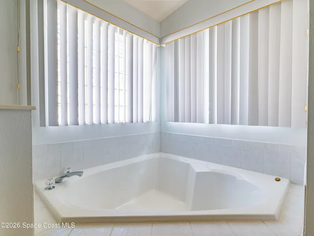 a white toilet sitting next to a shower