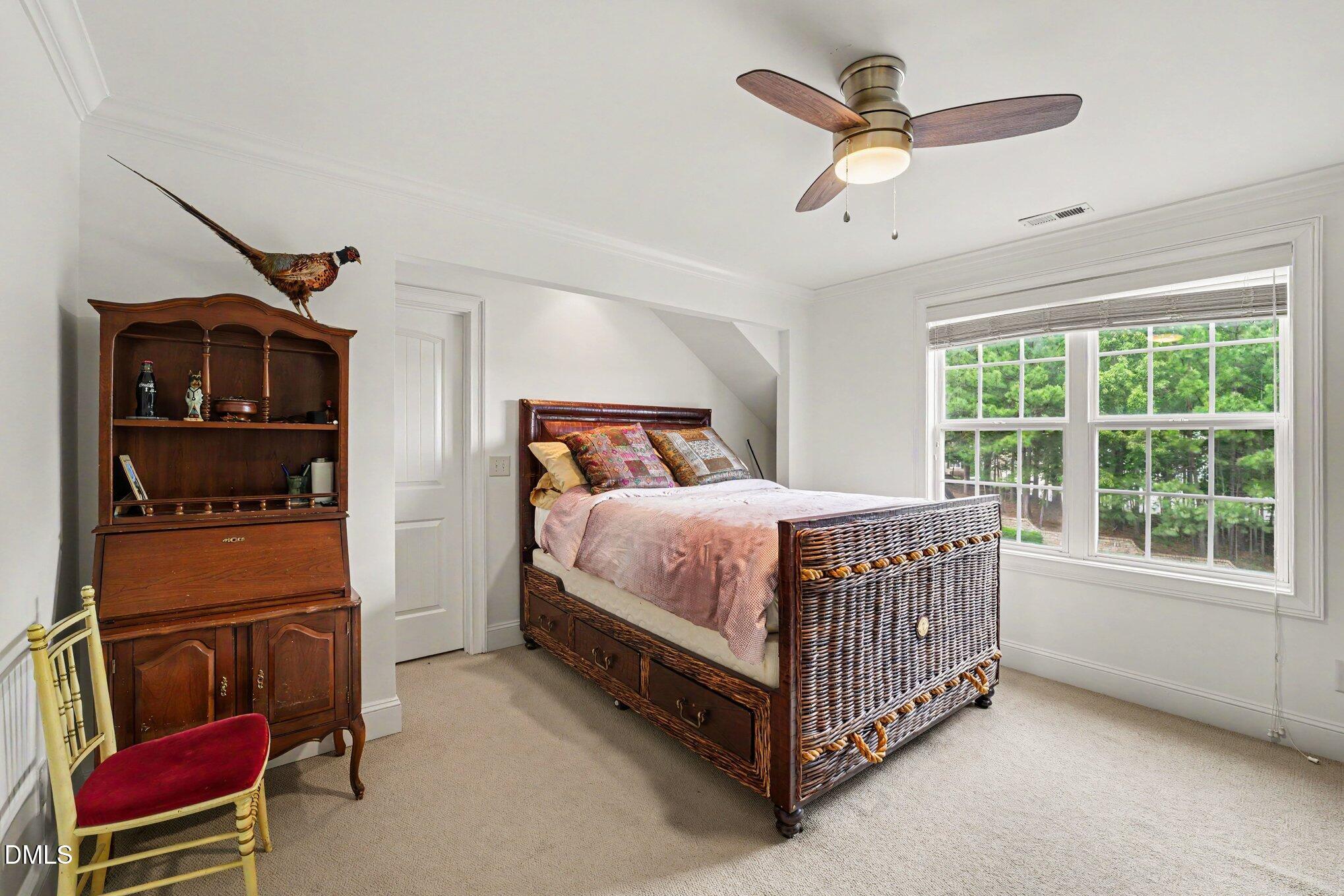 1729 Frenchwood Drive Raleigh, NC 27612 - Photo 21 of 46 a bed sitting in a room next to a window