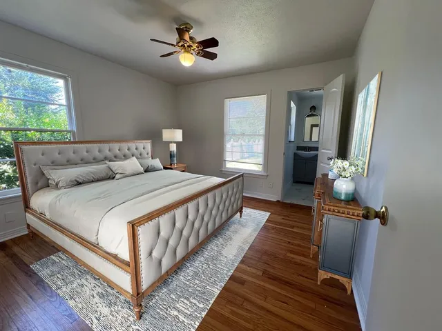 a bedroom with a bed and a chandelier