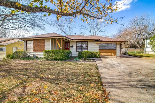 a front view of a house with a yard and outdoor seating
