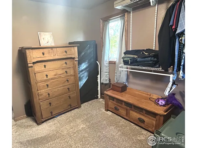 a living room with furniture and a mirror