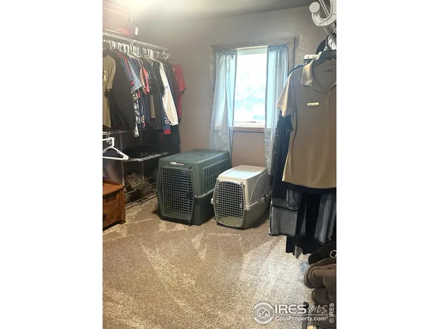 a view of a hallway with a chair and a mirror