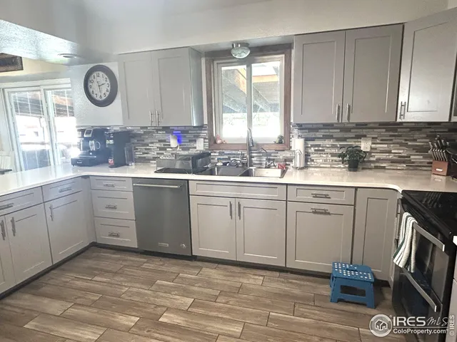 a kitchen with a sink cabinets and wooden floor