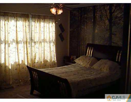 613 Edpas Road New Brunswick, NJ 08901 - Photo 6 of 7 a bedroom with a bed and a large window