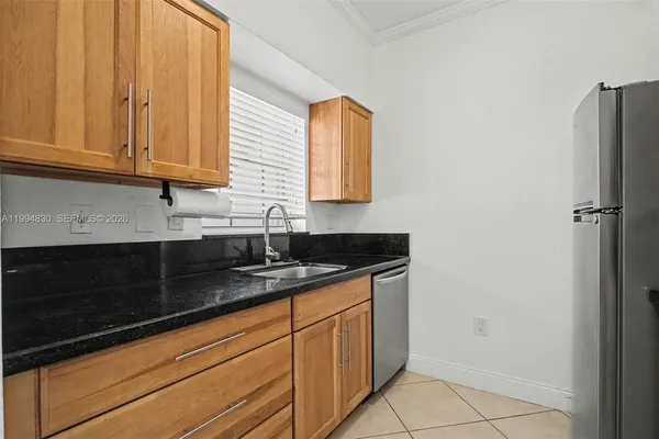 a kitchen with granite countertop a sink and cabinets