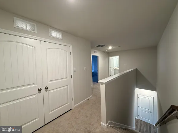 a view of a livingroom with workspace and a window