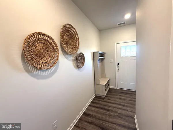 a living room with dining table and wooden floor